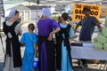 Amish family standing at table inspecting goods they might want to buy, Green Dragon Farmers Market, Ephrata, PA, 2016