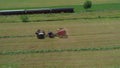 Amish Farmer Harvesting His Crop with 4 Horses and Modern Equipment Royalty Free Stock Photo