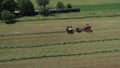 Amish Farmer Harvesting His Crop with 4 Horses and Modern Equipment Royalty Free Stock Photo