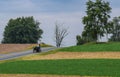 Amish Horse and Buggy Going Up a Hill