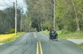 An Amish Open Buggy With 4 Boys on it Traveling on a Rural Road