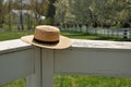 Amish straw hat on a white fence