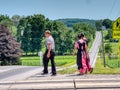 Amish Teenagers Walking Along Train Tracks in Countryside on a Sunny Day