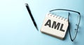 AML text written on a notepad on the blue background Royalty Free Stock Photo