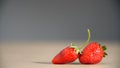 Two freshly picked red juicy strawberries lie on the table. Royalty Free Stock Photo