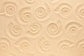 Ammonite print on sea sand. Top view. Copy space. Spiral pattern snail shell. Summer concept Royalty Free Stock Photo