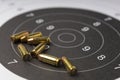 Ammunition and bullets on paper target for shooting practice Royalty Free Stock Photo