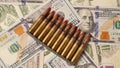 Ammunition from the gun on money bills. Bullets on dollars money, background. Lend-Lease concept. Army concept Royalty Free Stock Photo