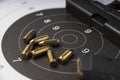 Ammunition and gun on paper target for shooting practice Royalty Free Stock Photo