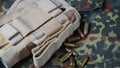 Ammunition and handgun holster on a camouflage background.