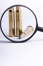 Ammunition on a white background. View through a magnifier. Isolated. Close up. Weapons. Royalty Free Stock Photo