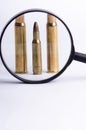 Ammunition on a white background. View through a magnifier. Isolated. Close up. Weapons. Royalty Free Stock Photo