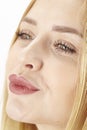Amorous attractive blond woman purses her lips