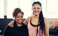 Amped to start exercising. Portrait of two cheerful young women having a conversation while looking into the camera Royalty Free Stock Photo