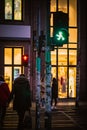 Ampelman walk sign in Berlin with people crossing the street