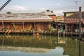 Amphawa Floating Market,Samut Songkhram Province,Thailand on April 13,2019:Buddhist monk rows the boat to receive food offerings f