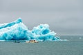 Amphibian vehicle with tourists in Jokulsarlon/Fjallsarlon glacier lagoon by the foot of Vatnajokull volcano.