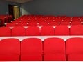 Amphitheater big lecture room with red chairs and white tables for students lined in rows for university or conference lectures Royalty Free Stock Photo