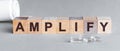 Amplify inscription word on wooden cube blocks on a table. covid symptoms concept Royalty Free Stock Photo