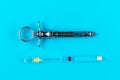 Ampoule with anesthesia, lidocaine or novocaine, needle and vintage metal syringe on blue background, dental health and