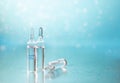 Ampoules on a beautiful bokeh background. Blurred photo of ampoules with injection liquid for background. Natural cosmetics. Royalty Free Stock Photo