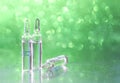 Ampoules on a beautiful bokeh background. Blurred photo of ampoules with injection liquid for background. Natural cosmetics. Royalty Free Stock Photo