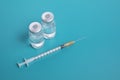 Close-up Syringe with two ampules on blue background Royalty Free Stock Photo