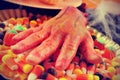 Amputated hand and Halloween candies, filtered Royalty Free Stock Photo