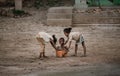 AMPYFY-MADAGASCAR-OCTOBER-17-2017:The child in Madagascar playing and `Take a bath`with older sister,Malagasy`s people village nea Royalty Free Stock Photo