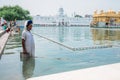 Amritsar, India - AUGUST 16: `Cleaner` of the holy pond around the Sri Harmandir Sahib or `Golden Temple` on August 16, 2016 in Am