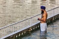 Sikh man praying and bathing in holy tank around Harmandir Sahi Royalty Free Stock Photo