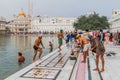 AMRITSAR, INDIA - JANUARY 26, 2017: Sikh devotees bathing in a pool in the Golden Temple Harmandir Sahib in Amritsar, Punjab, Ind Royalty Free Stock Photo