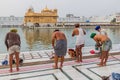 AMRITSAR, INDIA - JANUARY 26, 2017: Sikh devotees bathing in a pool in the Golden Temple Harmandir Sahib in Amritsar, Punjab, Ind Royalty Free Stock Photo