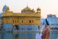 Tourists and worshipper walking inside the Golden Temple complex at Amritsar, Punjab, India, the most sacred icon and worship plac Royalty Free Stock Photo