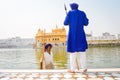 Unidentified Guard standing and looking around near Sri Harmandir Sahib or Golden Temple pond, i