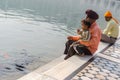 Amritsar, India - November 21, 2011: A Sikh family of pilgrims, father and son, are sitting near a lake in the Golden Temple Royalty Free Stock Photo