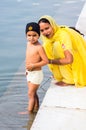 Amritsar, India - November 21, 2011: The Sikh family of pilgrims, mother and son, dresses up a bathing field in the lake in the Royalty Free Stock Photo