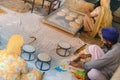 Amritsar, India - November 21, 2011: Unknown Indian people cook national bread for a free meal for pilgrims. Golden Temple in