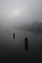 River Amstel in Amsterdam with houseboats and houses in dense fog Royalty Free Stock Photo