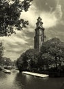 Amstel river and Westerkerk church in Amsterdam. Royalty Free Stock Photo