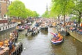 AMSTERDAM - APRIL 26: Amsterdam canals full of boats and people