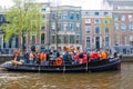 AMSTERDAM-APRIL 27: Locals and tourists have dance party on a boat King's Day along the Singel canal on April 27,2015.