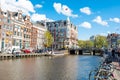 Amsterdam-April 30: Rokin canal with bikes parked along the bank, Hotel de l'Europe is visible in the background.