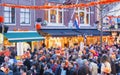 AMSTERDAM - APRIL 2013: Tourists along city streets. The city at Royalty Free Stock Photo