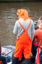 AMSTERDAM-APRIL 27: Undefined person in traditional orange on a boat during King's Day on April 27,2015.