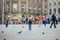 AMSTERDAM - AUGUST 2011: Little girl chasing pigeons on Dam Square in Amsterdam, Netherlands Royalty Free Stock Photo