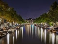 Night scene with reflection in a canal, Amsterdam Royalty Free Stock Photo