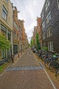 Amsterdam bicycles parked in old cobblestone street Royalty Free Stock Photo