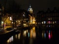 Amsterdam canal Amstel with typical dutch houses and houseboat from the boat in the evening, Holland, Netherlands Royalty Free Stock Photo