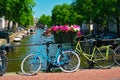 Amsterdam canal with boats and bicycles on a bridge Royalty Free Stock Photo